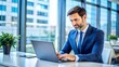 © imagemir - Businessman Working on a Laptop in a Modern Office