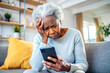 © Yekatseryna - Nervous confused elderly senior afro woman stressed worried with smartphone. Frustrated black granny having problem with paying, buying online and payments. Internet fraud or scams