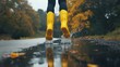 © pngking - Female Jumping into Puddle with Yellow Rubber Boots on Empty Road