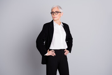 Poster - Photo portrait of pretty senior female professional entrepreneur look empty space wear formalwear specs isolated on gray color background