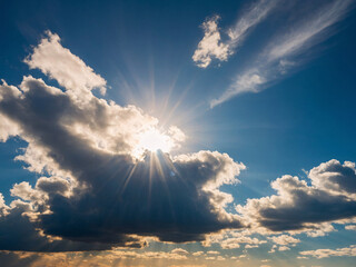 Wall Mural - Clear blue sky with clouds and sun in HD 4K. Stock wallpaper image. High contrast