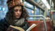 © sarana - Candid on Public Transport: A woman reading a book on a bus or subway, lost in her own world.