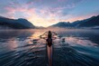 © Milos - A rowing team glides on a serene lake at sunrise, with mist-covered mountains in the background, reflecting the breathtaking blend of nature and human endurance.
