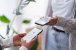 © Studio Marmellata - Two people engage in a digital payment transaction using their mobile phones The phones are close together, highlighting the ease of electronic transactions
