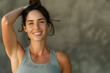 © StockLab - Woman in yoga outfit looking in the camera and smiling