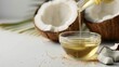 © EmPics - Pouring organic coconut oil into a small bowl, white backdrop, space for text, culinary use