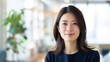 © Pro Hi-Res - Young japanese woman smiling in an office setting.