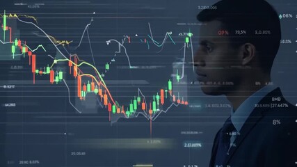 Wall Mural - A man in a suit looks on at a screen displaying stock market data, including a red line representing a downward trend.