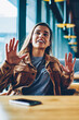© BullRun - Two happy hipster girls discussing ideas for attracting followers for shared blog in social networks indoors, successful female users communicated at comfortable cafeteria while waiting friend