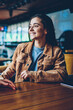 © BullRun - Two positive female persons enjoying informal meeting at campus, successful hipster girls talking to each other at cafeteria, happy young caucasian woman in conversation with best friend indoors