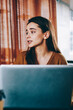 © BullRun - Millennial female friends making positive conversation in break of working on netbooks resting in wifi zone with coffee beverage, successful hipster girls recalls to pleasant moments spending together