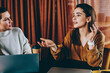 © BullRun - Attractive trendy women enjoying friendly conversation and free time togetherness at coffee shop, beautiful hipster girls casual dressed talking after working on laptop devices at cozy cafeteria