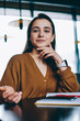 © BullRun - Portrait of attractive hipster girl looking at camera resting with female friend at coffee shop on leisure , gorgeous positive woman sitting at table with textbook for education and planning