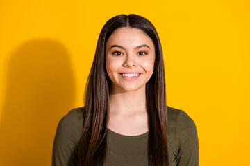 Wall Mural - Photo portrait of attractive teen woman look camera smile dressed stylish khaki clothes isolated on yellow color background