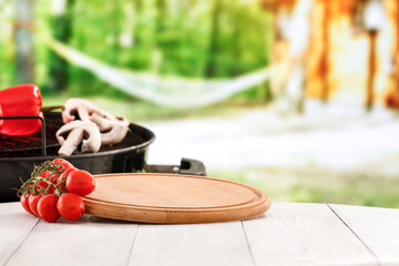 Poster - Grilled vegetables on white wooden garden table with blurred garden background. Grilling concept and copy space for products.