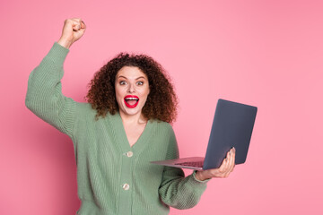 Wall Mural - Photo of charming cheerful glad woman wear stylish khaki clothes buy modern device isolated on pink color background