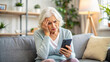 © Yekatseryna - Nervous confused elderly senior woman stressed worried with smartphone. Frustrated lady having problem with paying, buying online and payments. Internet fraud or scams