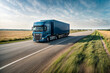 © Alex Vog - Export freight logistics transportation by van truck. Blue semi truck with container driving on highway at field background, fast motion effect. Import cargo travelling concept. Copy ad text space