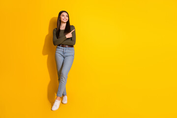 Poster - Full size photo of pretty teenager girl point look empty space wear trendy khaki outfit isolated on yellow color background