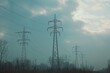 © Fotograf - Power transmission lines in an open field with rolling hills and blue sky