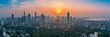 © Elmira - A panoramic view of Mumbai's skyline at sunset, showcasing the contrast between the dense urban development and the surrounding green areas, highlighting the urban heat island effect