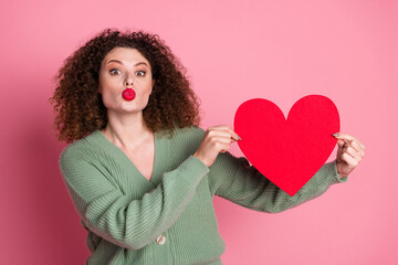 Wall Mural - Photo of lovely cute woman wear stylish khaki clothes hold red paper card isolated on pink color background