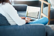 © Chanelle2000/peopleimages.com - Woman, laptop and screen with writing, proposal and project at home or apartment living room. Lady, couch and digital document for internet, connectivity or information for article on sofa in lounge