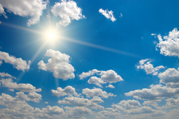 Wall Mural - bright sun on beautiful blue sky with white clouds.