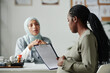 © pressmaster - Side view of young pregnant woman looking through document with medical prescriptions and keeping hand on her belly