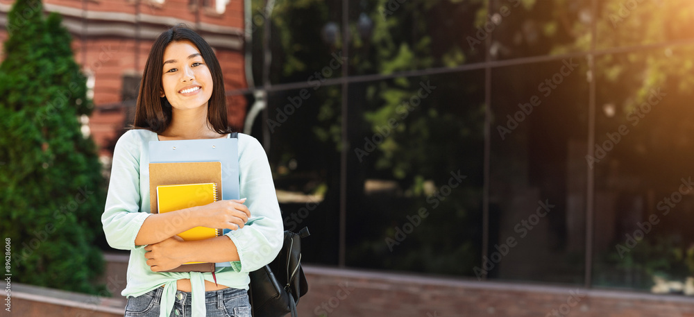 Portraif of smiling asian student girl with backpack and workbooks ...