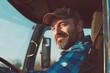 © vefimov - A man driving a semi-trailer truck with a beard and cap on. The photo has a grainy effect, possibly due to lighting conditions or post-processing.