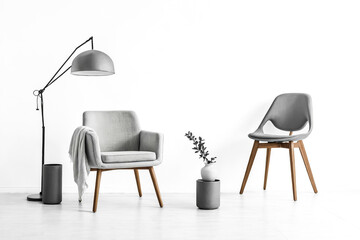 Sticker - Grey armchair with a floor lamp and chair in white room