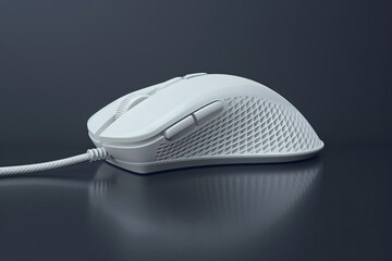 a white computer mouse on a black surface