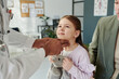© pressmaster - Hands of mature male doctor on neck of cute little patient with soft toy during examination of thyroid at medical consultation in clinics