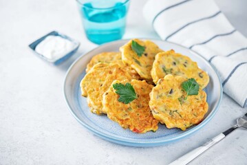 Poster - Corn fritters with cream sauce in a plate