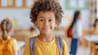 © Claudia Nass - six year old dark skinned school boy with a bagpack in classroom