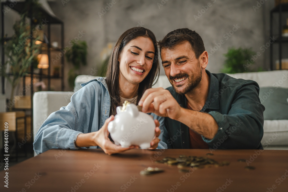 Adult couple save money coins in the piggy bank at home Stock Photo ...