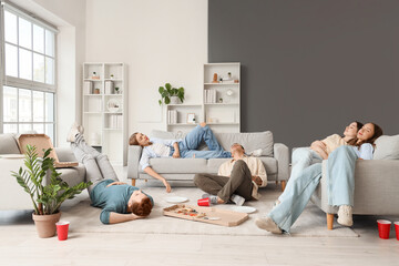 Canvas Print - Group of young friends full of pizza at home party