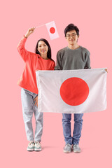 Sticker - Young Asian couple with flags of Japan on pink background