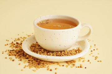 Poster - Cup of tasty fresh buckwheat tea on beige background, closeup