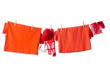 Wall Mural - Clean clothes and underwear hanging on rope against white background