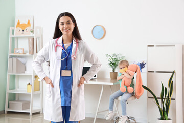 Canvas Print - Female pediatrician with stethoscope in clinic