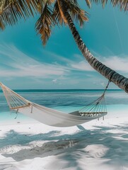 A hammock suspended between two palm trees on a peaceful beach