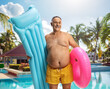 © Ljupco Smokovski - Man in swimwear on a summer holdiay with a mattress and swim ring at a pool