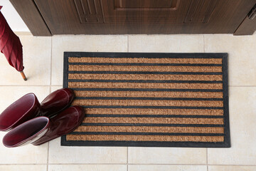 Wall Mural - Brown door mat, umbrella and shoes on floor in hallway