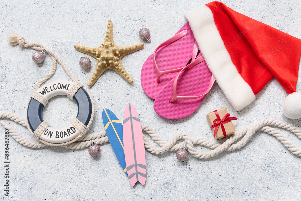 Santa's hat and beach accessories on white background. Top view