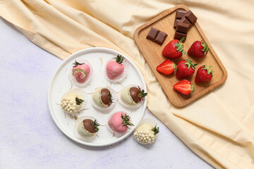 Wall Mural - Plate with chocolate covered strawberries and wooden board of fresh berries on white background