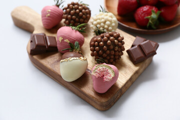 Wall Mural - Wooden board with chocolate covered strawberries on grey background