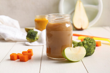 Wall Mural - Glass jar of healthy baby puree on light wooden table