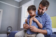 © Sanc/peopleimages.com - Dad, son and help getting ready in morning to start school with support, growth or development in home. Bedroom, father and child tying shirt for dressing routine with love, care and matching clothes